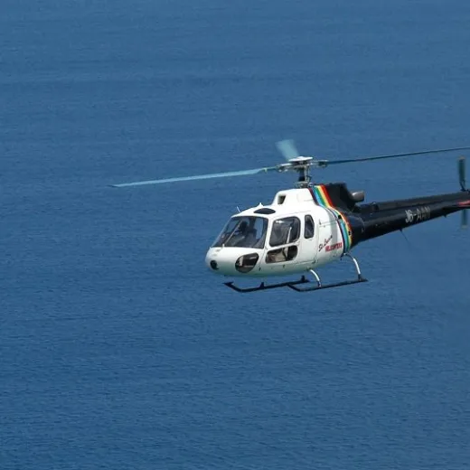 a small airplane flying over a body of water