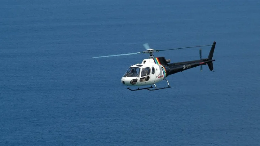 a small airplane flying over a body of water